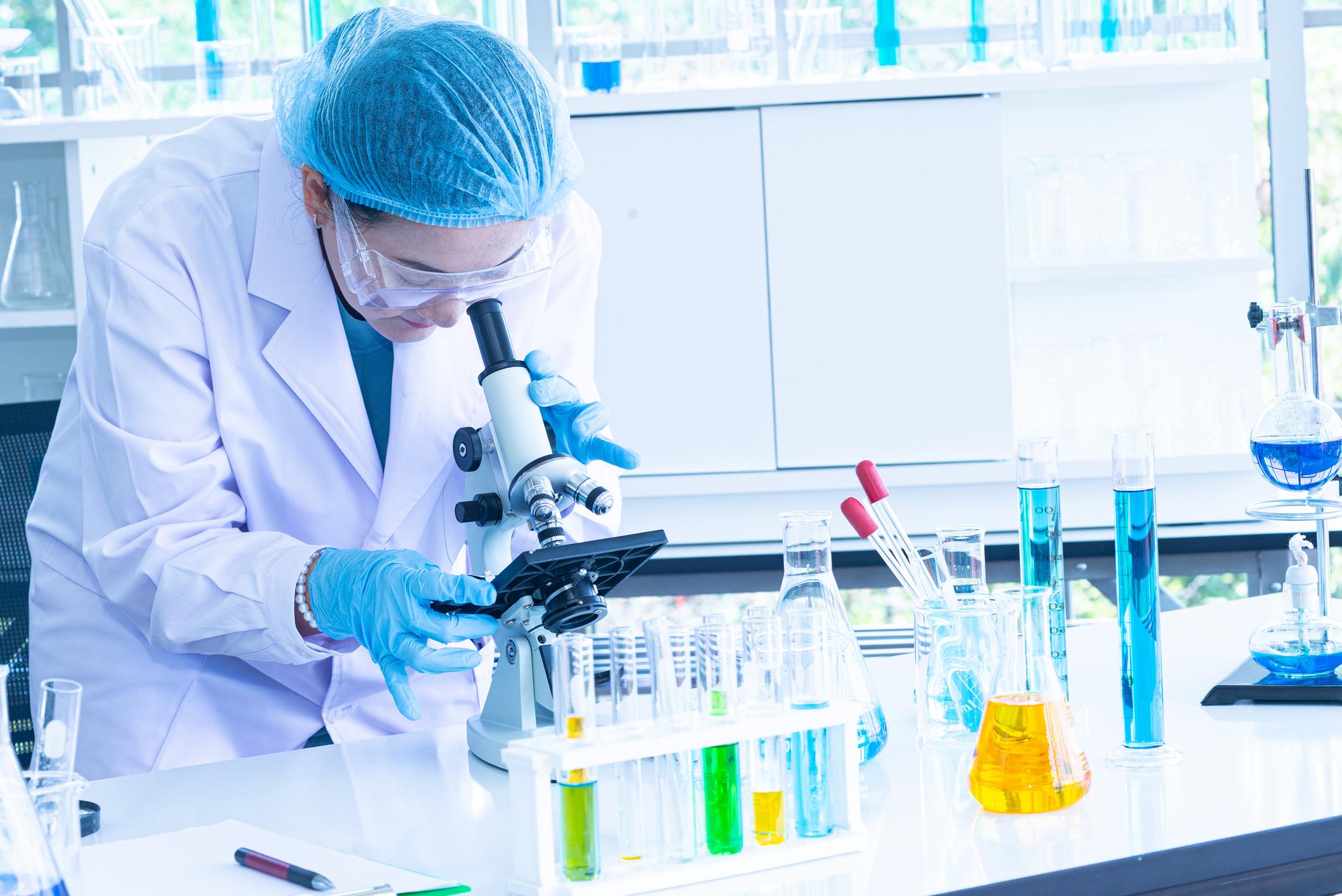 Asian woman scientist, researcher, technician, or student conducted research in laboratory Asian woman scientist, researcher, technician, or student conducted research or experiment by using microscope which is scientific equipment in medical, chemistry or biology laboratory